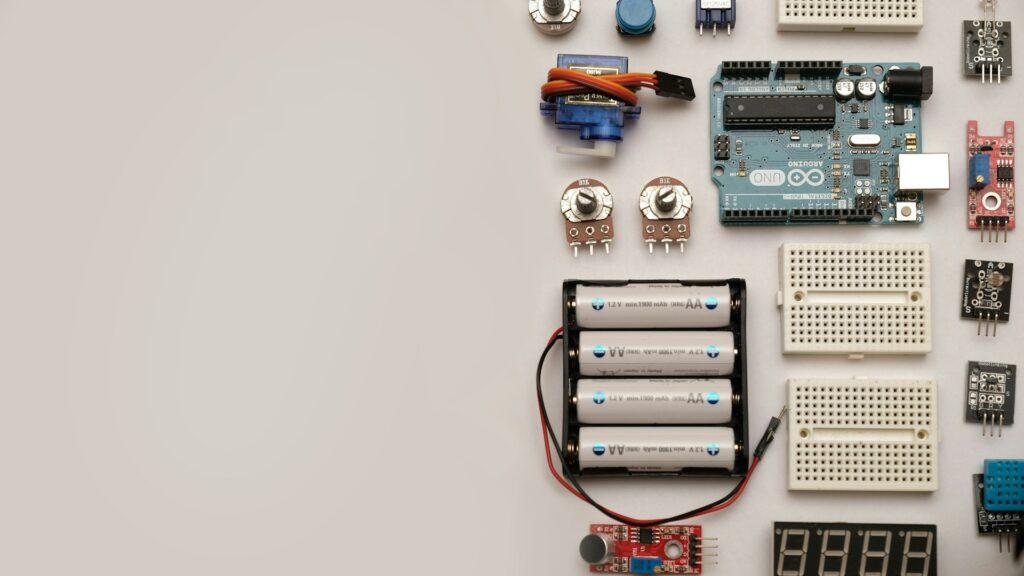 Various electronic components and sensors arranged on a table, showcasing the importance of integrating hydrogen sensors in modern electronics for improved safety and functionality.